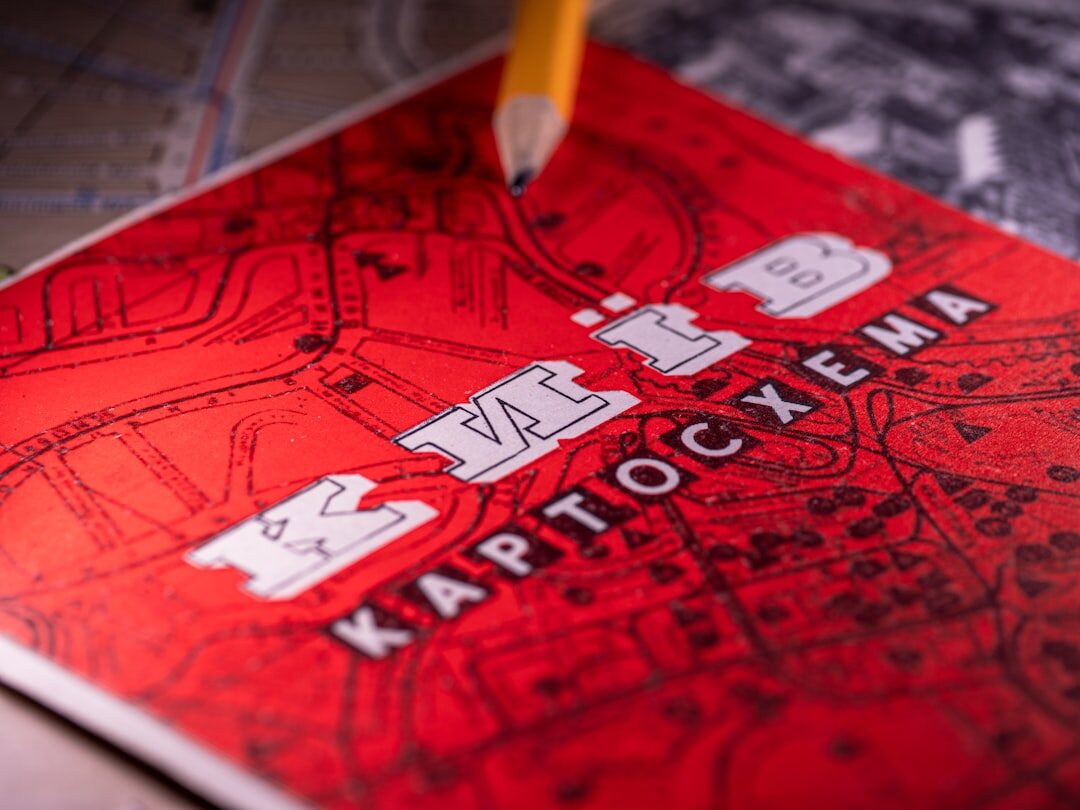 Illustrated detective book cover featuring an oversized magnifying glass over a city map